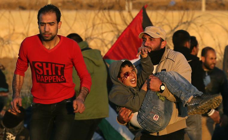 A wounded Palestinian boy is evacuated during a protest at the Israel-Gaza fence, in the southern Gaza Strip January 11, 2019.