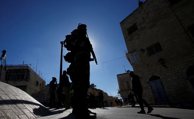 A member of Palestinian security forces stands guard before the arrival of Theophilos III, the Greek Orthodox Patriarch of Jerusalem, in Bethlehem, in the Israeli-occupied West Bank January 6, 2019. 