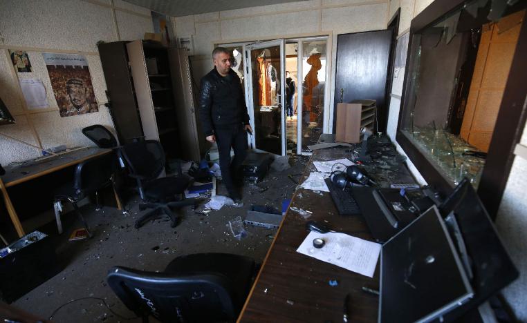 An employee of the Palestinian government-run radio and television stations inspects the damage at one of the studios on January 4, 2019, after armed men reportedly raided the building in Gaza City.