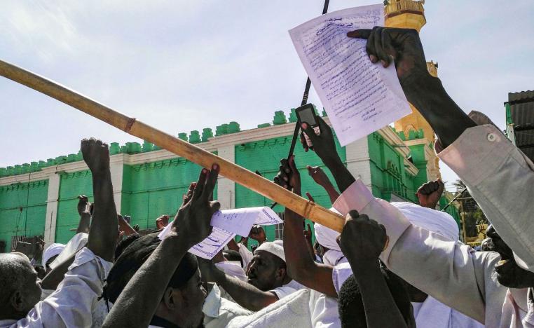 Sudanese protesters chant slogans and raise signs against President Omar al-Bashir during a demonstration in the capital Khartoum's twin city of Omdurman on January 25, 2019.