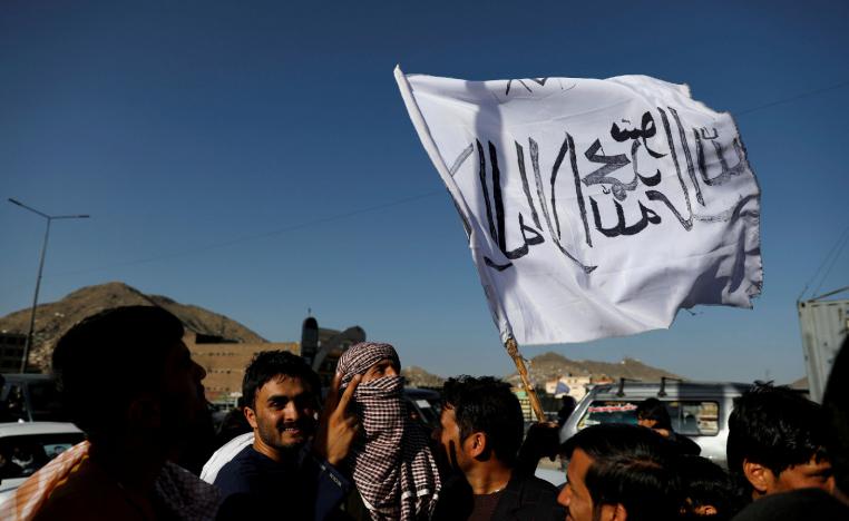 A member of the Taliban holds a flag in Kabul, Afghanistan June 16, 2018.
