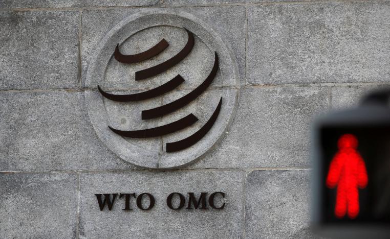 A logo is pictured outside the World Trade Organization (WTO) headquarters next to a red traffic light in Geneva, Switzerland, October 2, 2018.