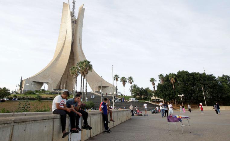 Youths sit near the Martyrs' Memorial in Algiers, Algeria September 10, 2018.