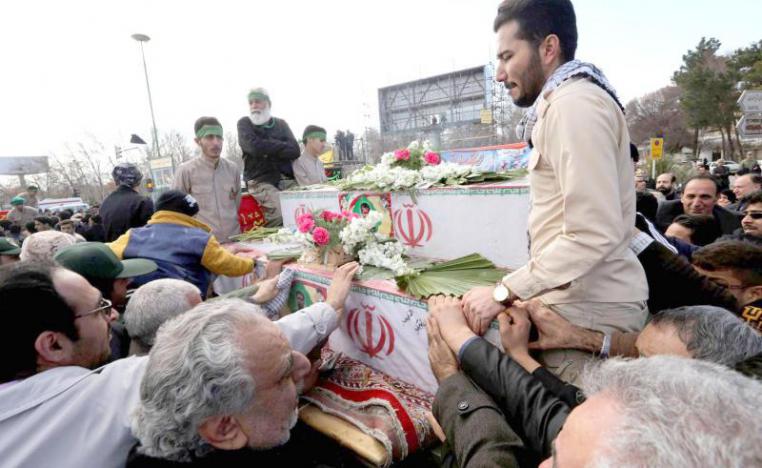 Iranian mourners gather around the coffins of members of Islamic Revolutionary Guard Corps who were killed February 13 in a suicide attack, during their funeral in Isfahan, February 16