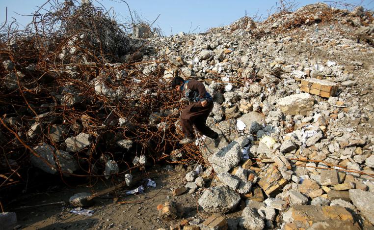 Homeless boys search for scrap in the remains of the former National Insurance Company building in the Old City of Mosul, Iraq February 1, 2019. 