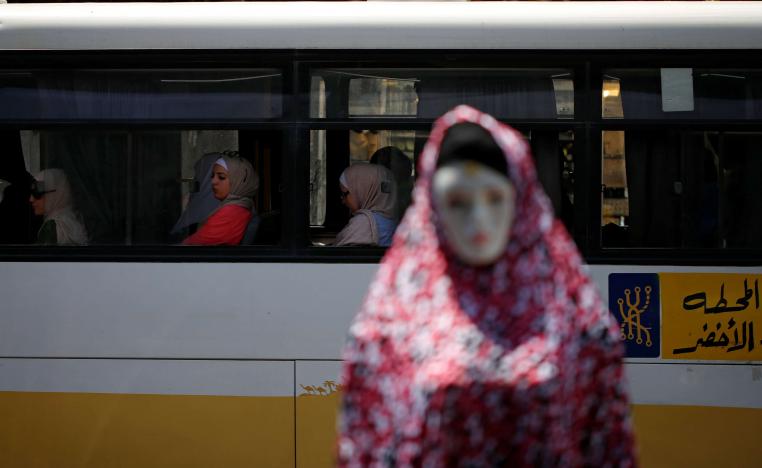 A mannequin is pictured as women ride a bus in Amman, Jordan June 6, 2018.