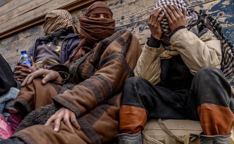 Men suspected of being Islamic State (IS) wait to be searched by members of the Kurdish-led Syrian Democratic Forces (SDF) after leaving the IS group's last holdout of Baghouz, in Syria's northern Deir Ezzor province on February 27, 2019.