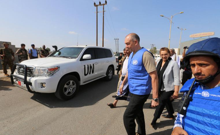 Danish Major General Michael Lollesgaard, who heads a U.N. team tasked with monitoring a ceasefire between Houthis and Yemeni government forces, walks by a convoy of a U.N. and WFP team crossing from Houthi-controlled areas to a government-controlled areas to reach grain mills in an eastern suburb of Hodeidah, Yemen February 26, 2019.