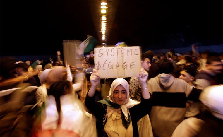 People take part in a protest demanding immediate political change in Algiers