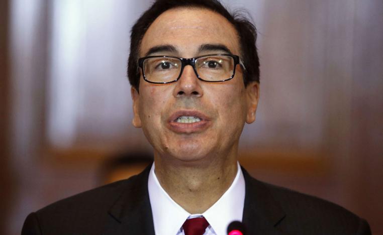 In this Oct. 16, 2018, photo Treasury Secretary Steve Mnuchin leads a meeting of the Financial Stability Oversight Council at the Treasury Department in Washington.