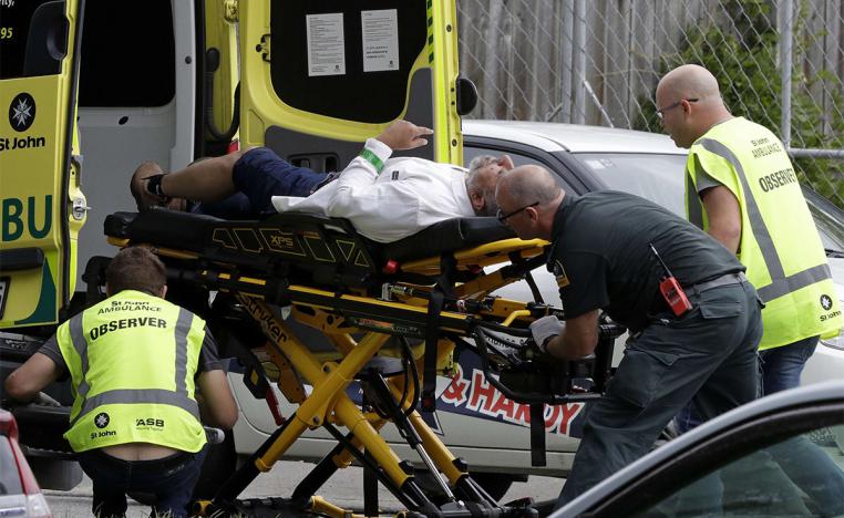 Ambulance staff take a man from outside a mosque in central Christchurch