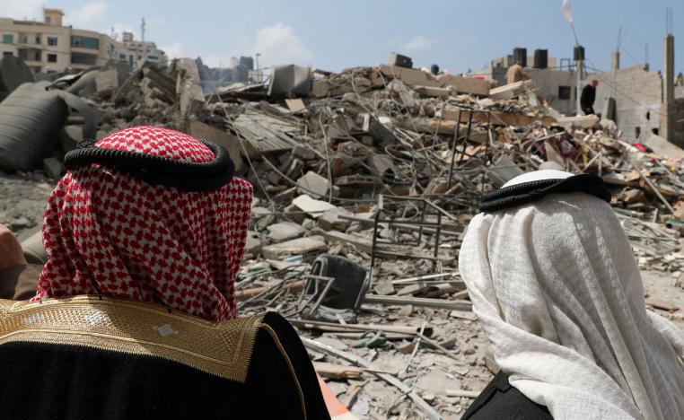 Palestinians look at a destroyed Hamas site that was bombed in an Israeli air strike on Monday, in Gaza City March 27, 2019.