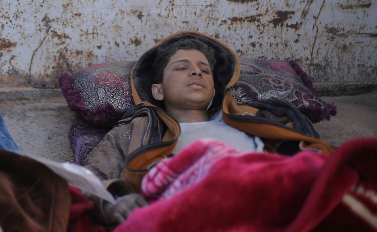 Hareth Najem, an Iraqi orphan lies under a blanket in a truck, near the village of Baghouz, Deir Al Zor province, Syria March 1, 2019. Picture taken March 1, 2019.