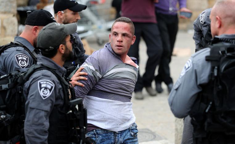 Israeli policemen detain a Palestinian protester during scuffles outside the compound housing al-Aqsa Mosque in occupied East Jerusalem's Old City March 12, 2019.