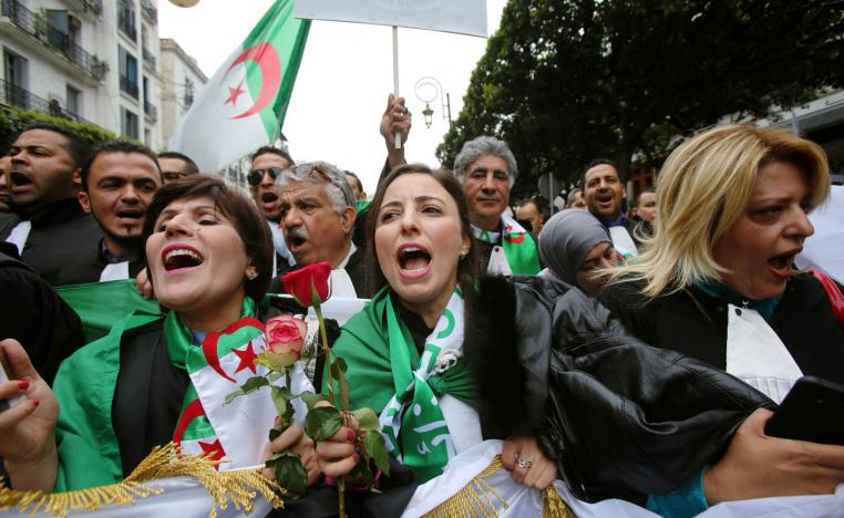 Lawyers carry national flags and flowers as they march during a protest to demand the immediate resignation of President Abdelaziz Bouteflika, in Algiers, Algeria March 23, 2019.