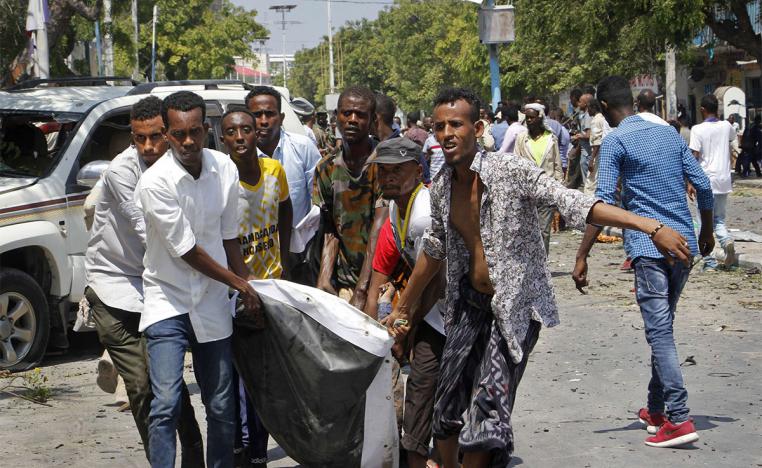 Somalis carry away a man who was wounded in the blast