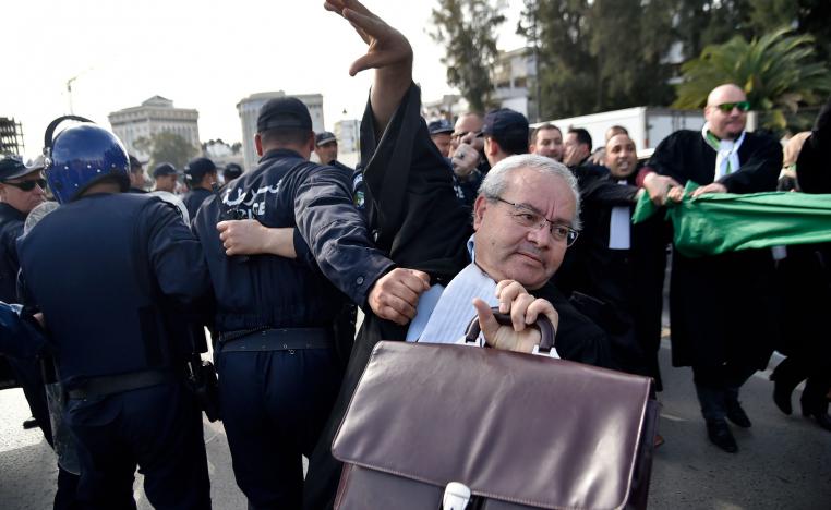 Algerian police disperse a protest by lawyers and journalists against their ailing president's bid for a fifth term in power, in Algiers on March 7, 2019.