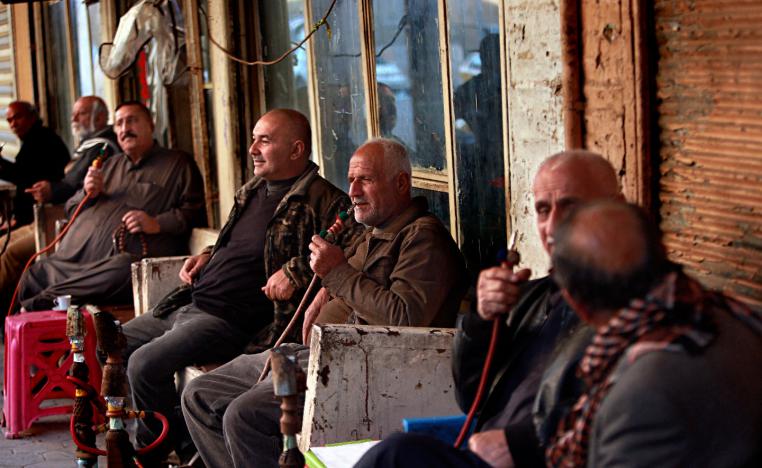 Patrons sit outside Hassan Ajami cafe in al-Rasheed street, the oldest street in Baghdad, Iraq, Saturday, March 2, 2019.