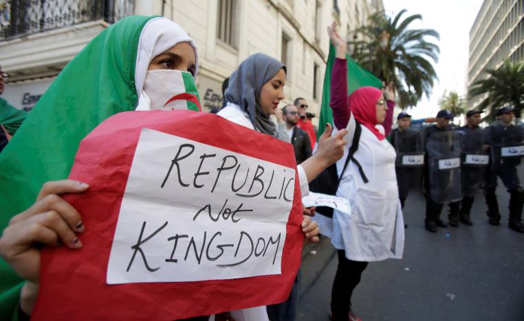 A demonstrator carries a sign as teachers and students take part in a protest demanding immediate political change in Algiers, Algeria March 13, 2019. 