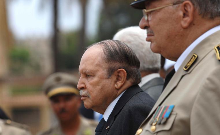 In this picture taken on June 27, 2012, Algerian President Abdelaziz Bouteflika, left, and his Army chief of staff, Gen. Ahmed Gaid Salah, review an honor guard before attending a military parade, in Cherchell near Algiers, Algeria.