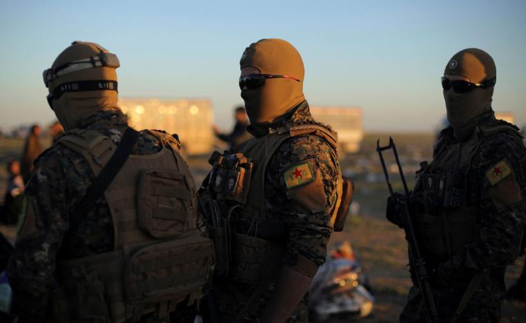 Fighters of Syrian Democratic Forces (SDF) stand together near the village of Baghouz, Deir Al Zor province, Syria March 1, 2019.