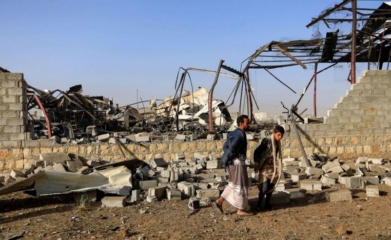  Civilians inspect the damage after a reported airstrike by Saudi-led coalition