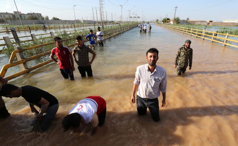 Barricades are set up to contain water in a flooded street in the city of Ahvaz, the capital of Iran's Khuzestan province