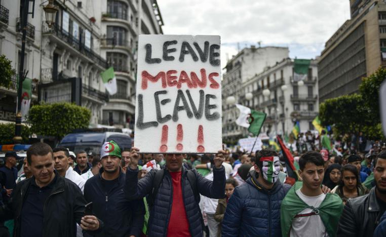 Algerians raise a placard as they take part in an anti-government demonstration, on April 5, 2019 in the capital Algiers. 