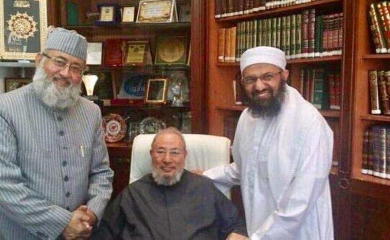 Qaradwi (C) with National Towheed Jamaat in his office in Qatar