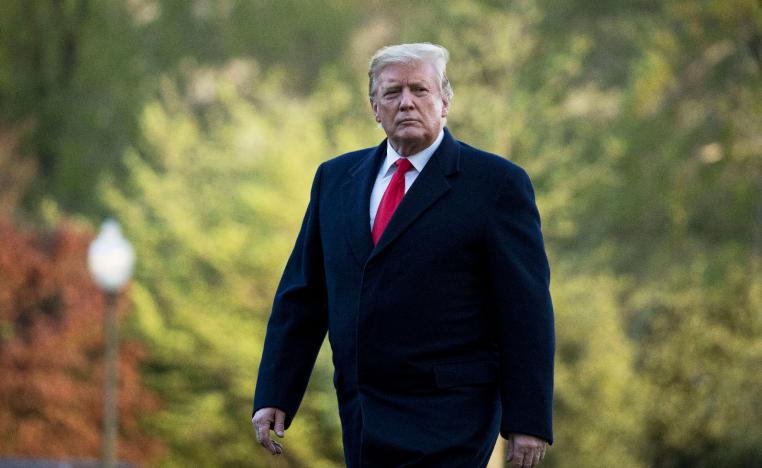 President Donald Trump walks on the South Lawn as he arrives at the White House in Washington