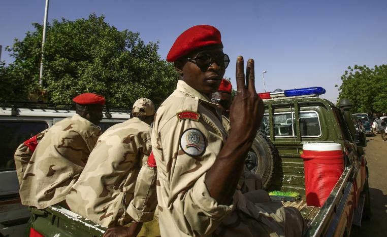 A Sudanese soldier flashes the victory sign