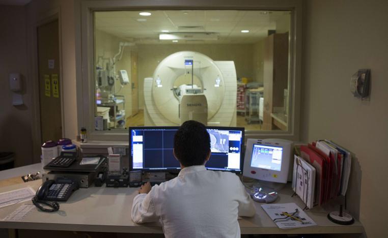 طبيب يفحص دماغ مريض بالرنين المغناطيسي 