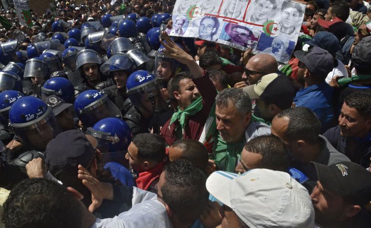 Algerian protesters chant slogans outside the central post office in Algiers
