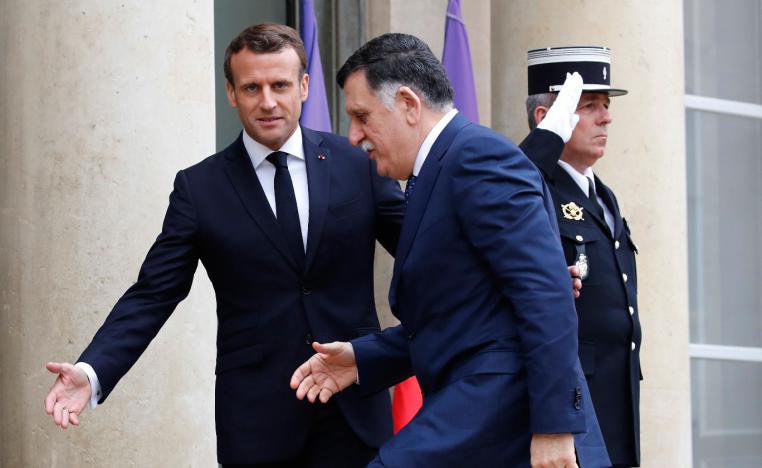 French President Emmanuel Macron (R) welcomes Libyan Prime Minister Fayez Sarraj
