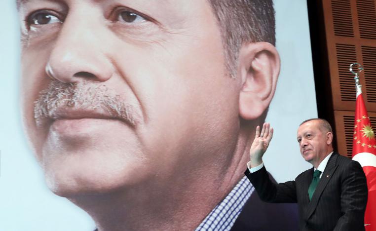 Erdogan gestures as he arrives to deliver a speech to members of his ruling Justice and Development Party
