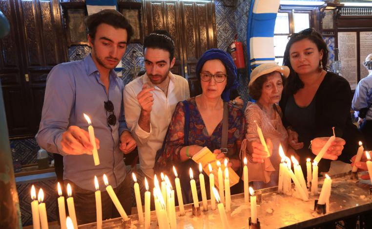 Jewish pilgrims light candles on the first day of the annual pilgrimage to the El Ghriba Synagogue