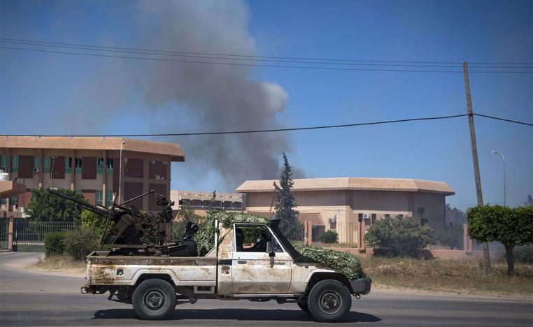 Smoke rises above buildings in Espiaa, south of Tripoli