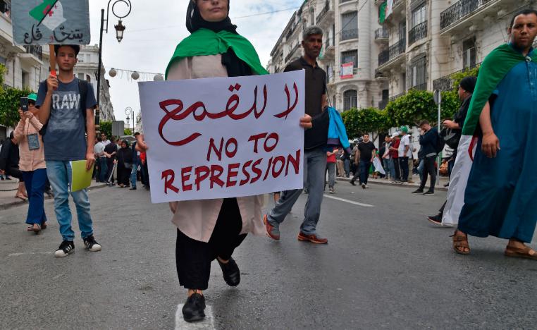 An Algerian protester carries a placard during an anti-government demonstration in the capital Algiers