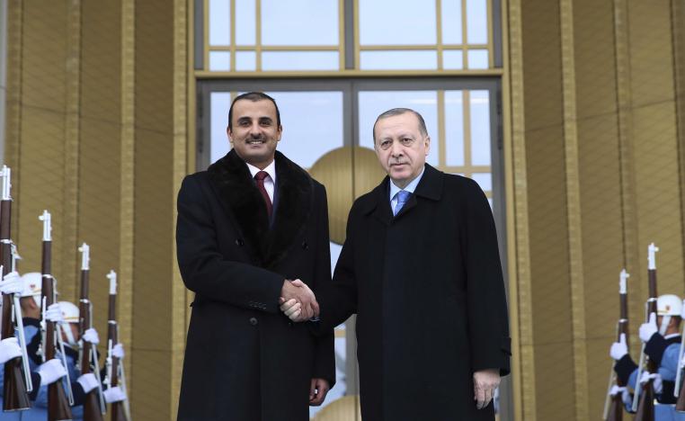 Turkey's President Recep Tayyip Erdogan, right, shakes hands with Qatar's Sheikh Tamim bin Hamad Al Thani