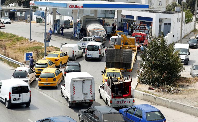 Automobiles line up for gasoline at a gas station in Tunis