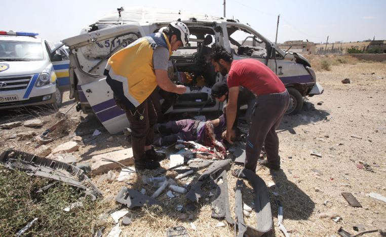 Injured medic receives help after an ambulance was destroyed by a Syrian government air strike