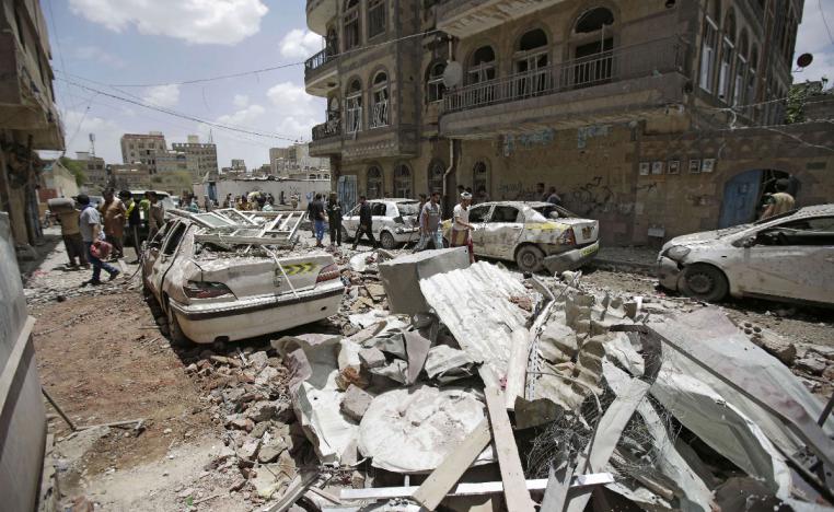 People inspect the site of an airstrike by Saudi-led coalition in Sanaa