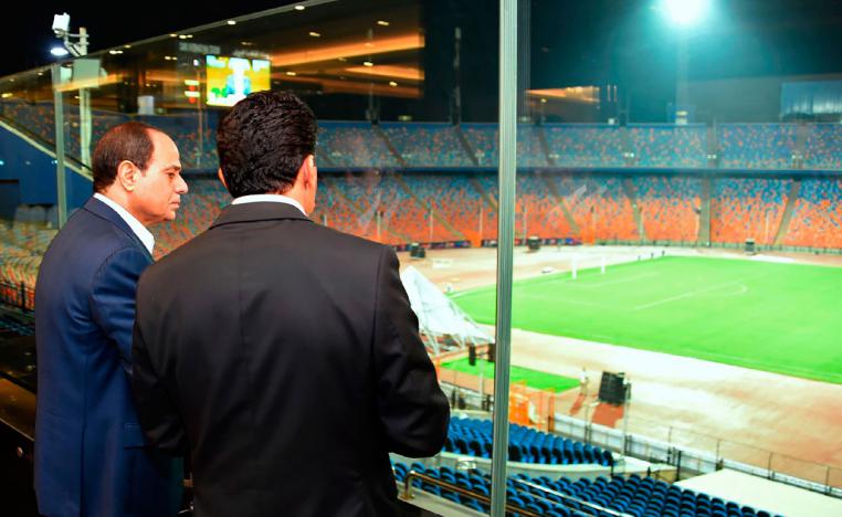 Egyptian President Abdel-Fattah el-Sissi, left, inspects Cairo Stadium
