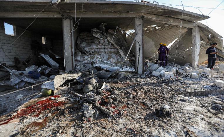 Members of the Syrian Civil Defence attempt to clear debris as they search for bodies
