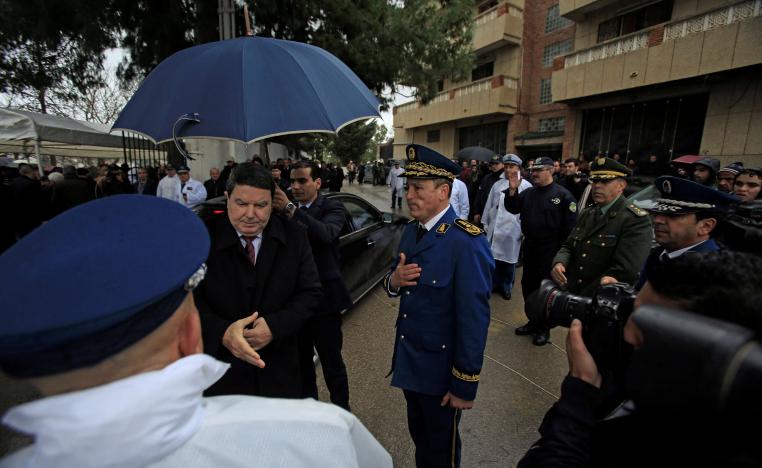 Abdelghani Hamel, former Director General of the Algerian National Police (DGSN) greets a police officer in Algiers, Algeria, March 7, 2016