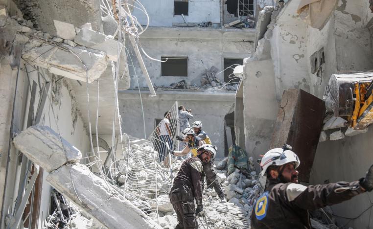 Members of the Syrian Civil Defence search for victims or survivors after an air strike