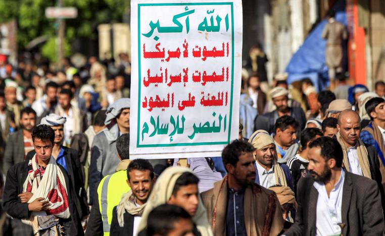 Supporters of Yemen's Huthi rebels march with the groups emblem, reading in Arabic "God is Great, death to America, death to Israel, curse upon the Jews, victory for Islam"