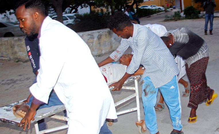 Medical workers help civilian on stretcher who was wounded in the suicide bombing