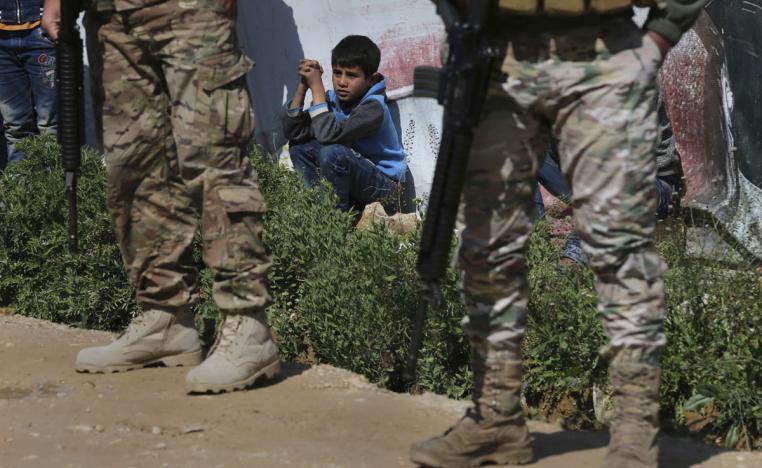 A Syrian refugee boy watches the opening ceremony of a school for Syrian refugees