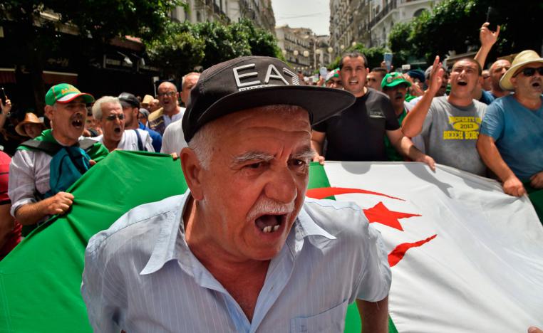 Algerian protesters shout slogans as they demonstrate in Algiers
